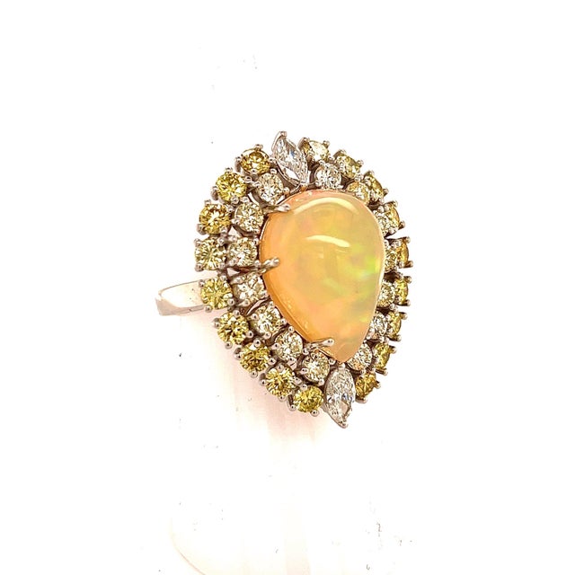 This Magnificent, Custom-Made Natural Fine Quality Pear-Shaped Opal and Diamond Ring is a one-of-a-kind creation that...