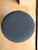 Contemporary round ottoman upholstered in a rich navy textured fabric for a refined, versatile look. Its clean, tailored...