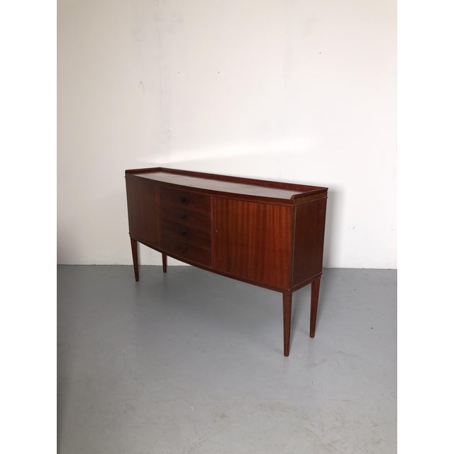 Refined mahogany sideboard with a warm, intense reddish color, 1950s designed by Vanzania, a renowned Italian company from...
