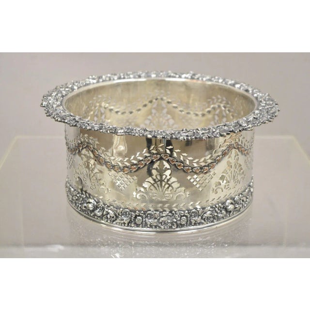 English Sheffield Sterling Silver Mounted Silver Plated Champagne Bottle Coaster. Item features floral pierced design with...