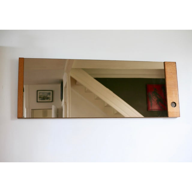Large smoked mirror with an asymmetrical frame, 1970s. Black marks on the wood frame, minor age-related misalignment...