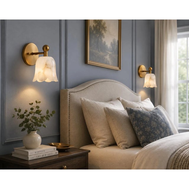Bring refined craftsmanship to the interior with this handcrafted pair of solid brass wall sconces featuring sculpted...