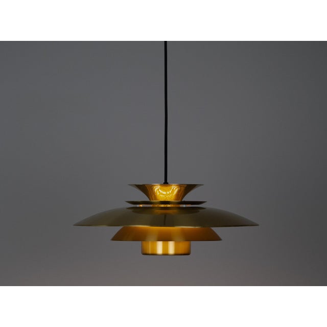 The lamp's form was designed based on the principle of a reflective system that directs light not only downward but also...
