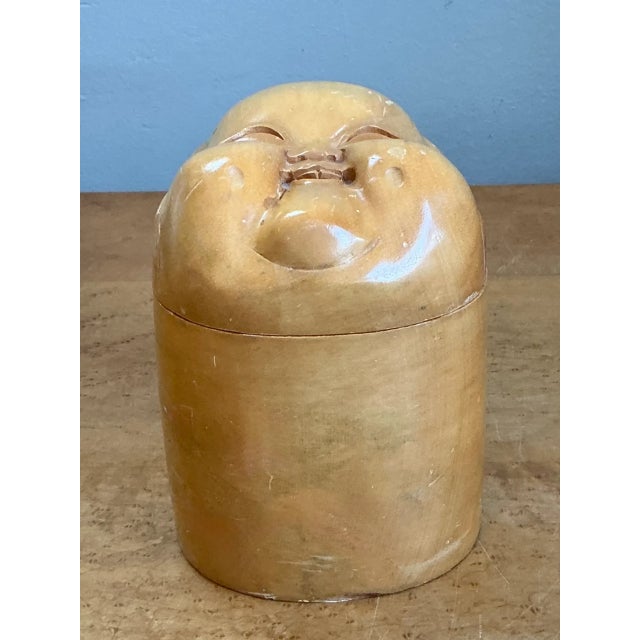 Charming and tactile, this vintage carved wood smiling face box brings a playful Boho accent and handcrafted character to...