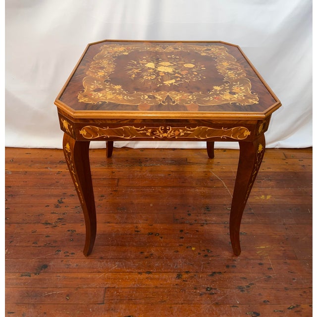This table features a beautiful top with a multi color floral inlay. The table can be set up with inlaid side featuring...