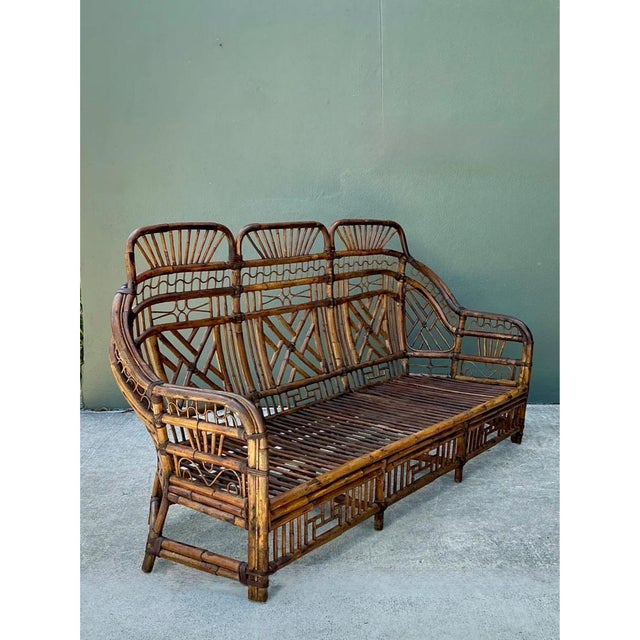 Handcrafted in heavy bent rattan with leather-wrapped corner bindings, this mid-century three-seat sofa captures the grand...
