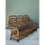 Handcrafted in heavy bent rattan with leather-wrapped corner bindings, this mid-century three-seat sofa captures the grand...