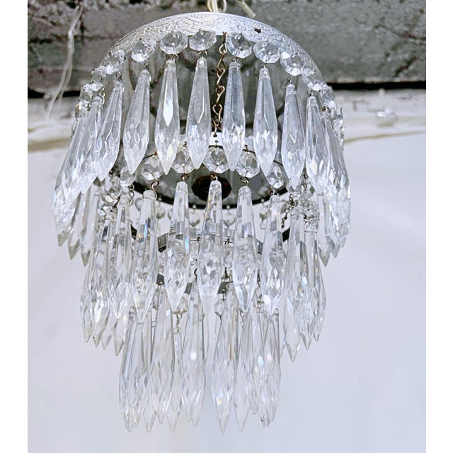 This is an Italian silver rim chandelier dressed with octagon beads and U-drop crystals drops. It has one Edison base...