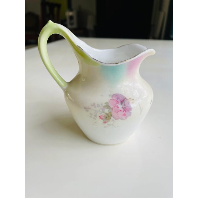 Vintage floral design small pitcher , creamer 4.5"H X 4"W X 3.5"D, Makers mark reads" R.S Prussia" very good condition...