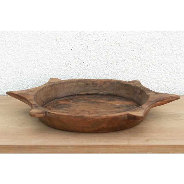 The sculptural form of this vintage bowl takes center stage. Carved from a single piece of solid hardwood, it features a...