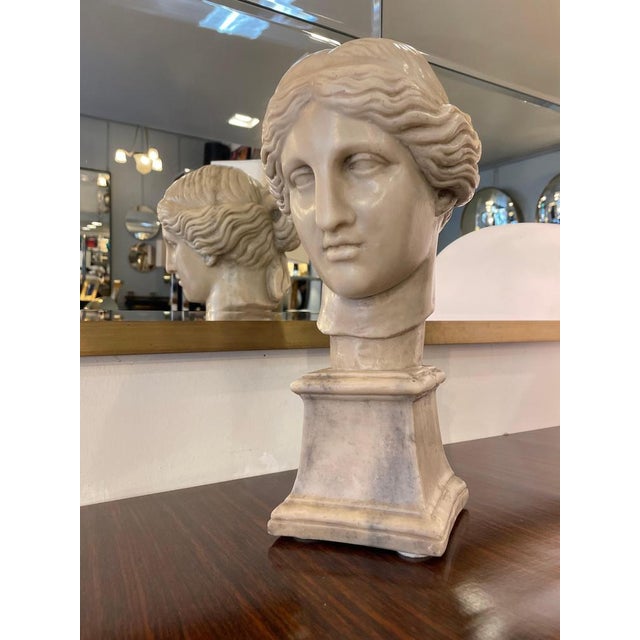 Marble bust depicting aphrodite (venus), the greek goddess of beauty and love. Carved from white marble, it features a...
