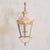 A French aged lantern sconce dating to the 1950s. Crafted from metal, the sconce features an elegantly curved arm adorned...
