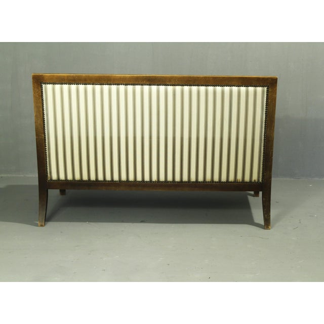 Sturdy beechwood sofa; reupholstered at a later date; minor stains on the upholstery and a small 1-cm tear (see photo);...