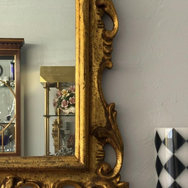 A showstopping example of the Florentine gilded mirror tradition, this substantial Rococo Revival wall mirror features an...