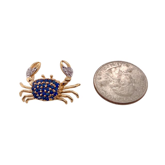 This is a fine vintage 14K gold brooch in the form of a crab. The body of the crab has prong set sapphires. The claws have...