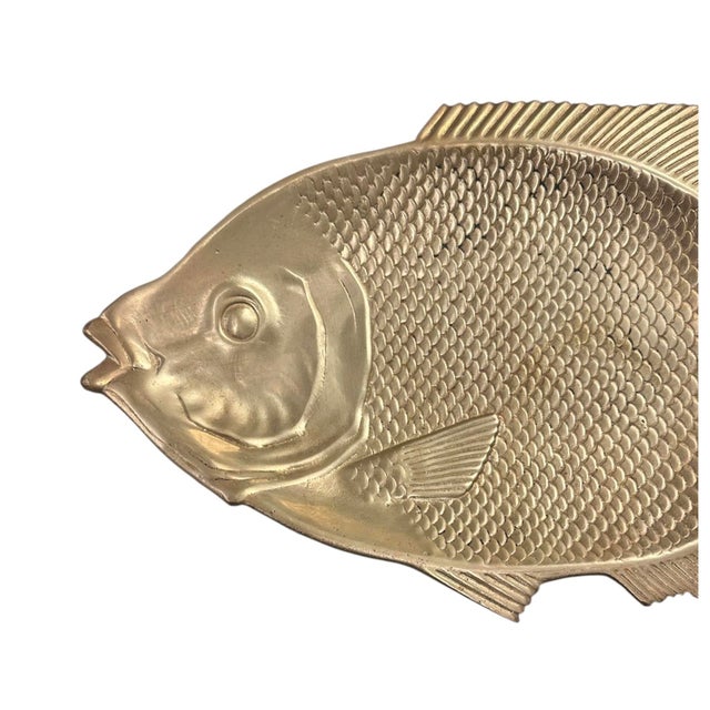 A charming, vintage brass tray. Features a heavy weight, cast fish in solid brass. Unmarked. Circa 1980.