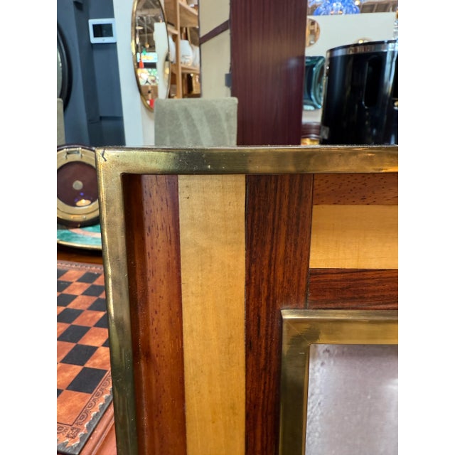 This mid-century modern photo frame combines the warmth of natural wood with the sophistication of brass detailing. The...