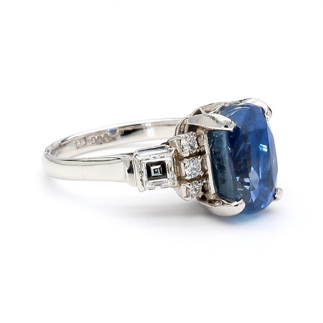 GIA Certified Natural 2.51 carat oval blue sapphire measuring 9.6 x 5.6mm is set in a platinum 900 vintage ring with 0.45...