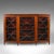 This is a large antique breakfront bookcase. An English, walnut display cabinet with astragal glazed doors in Georgian...