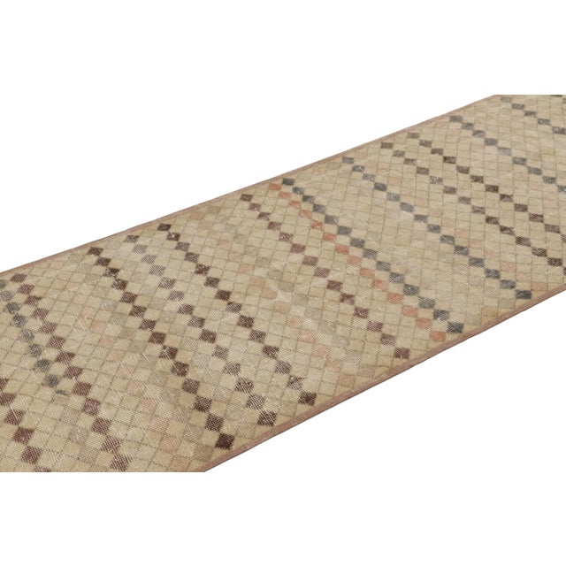 This vintage rug is a 3x10 Turkish distressed piece, made with hand-knotted wool circa mid-20th century. It is an exciting...