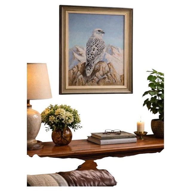 A striking original wildlife painting depicting a majestic white falcon or gyrfalcon perched prominently upon a rugged...