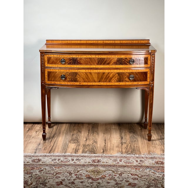 Inspired by the elegant proportions of early American Federal furniture, this vintage bow front sideboard by the renowned...