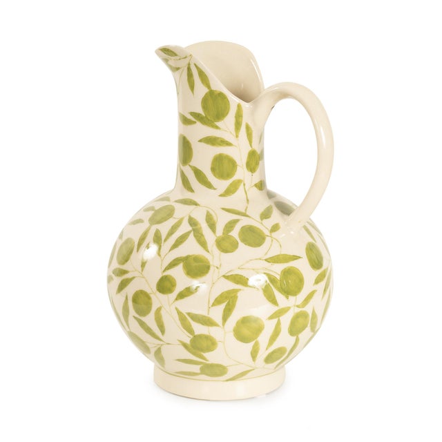 The soft, rounded silhouette is adorned with a lively sage green leaf motif, perfect for adding a natural touch to your...