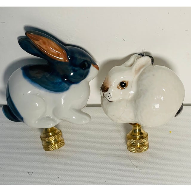 Gorgeous pair of vintage porcelain rabbit figurines mounted on a brass bases as lamp finials.