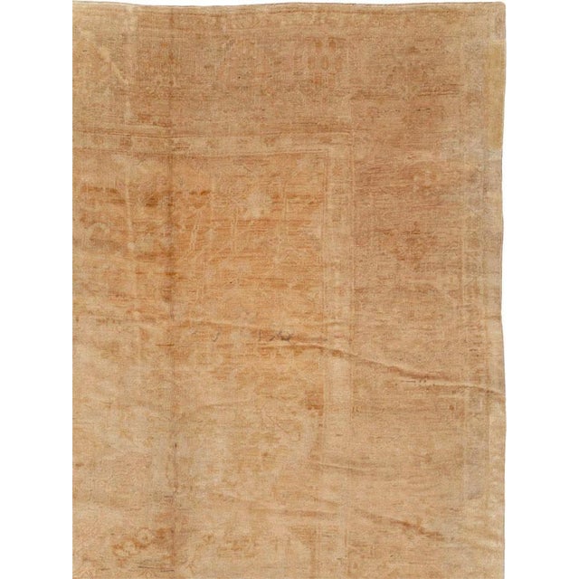 An antique Turkish Oushak large room size carpet handmade during the early 20th century in gold and beige tones. Measures:...