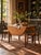 An antique drop-leaf dining table featuring beautifully grained wood, turned and fluted legs, and original casters. The...