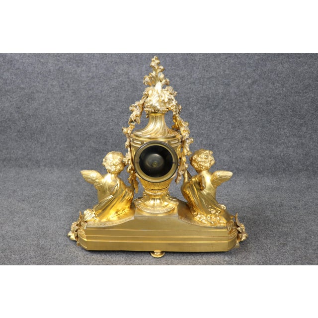 This magnificent French gilt bronze figural clock by Samuel Marti, retailed by the prestigious Parisian firm Barraud et...