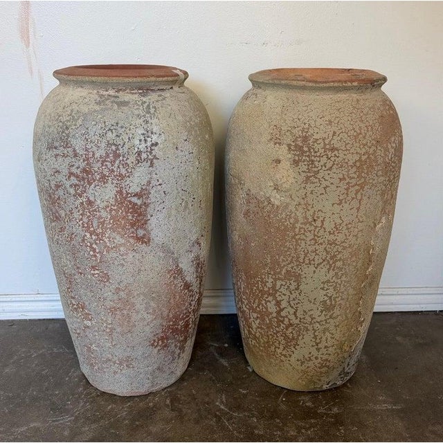 A magnificent and highly atmospheric pair of monumental water jar or olive jar planters, embodying the true soul of Wabi-...