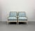 A stylish pair of contemporary lounge chairs featuring sculptural bobbin-turned frames finished in a soft ivory lacquer....