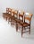 An exceptional set of six antique French farmhouse dining chairs featuring turned legs, textured rush seats, and a warm...