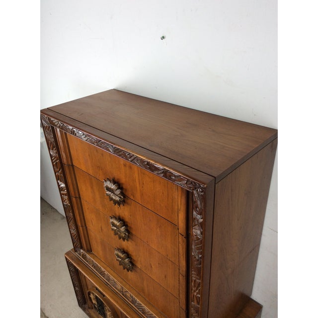 This mid century modern armoire features hardwood construction, original oak finish with unique carved detailing, six...