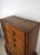 This mid century modern armoire features hardwood construction, original oak finish with unique carved detailing, six...