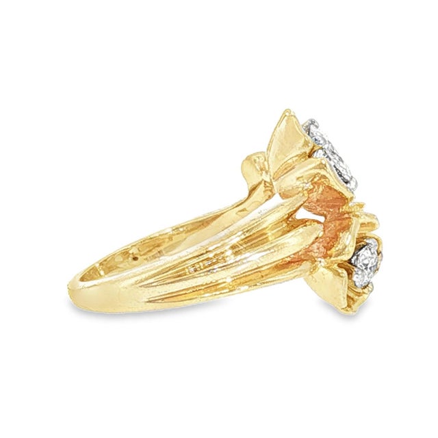 A Mid-century 14k yellow gold floral design ring. Features two Old European cut diamonds. The primary diamond is 0.4...