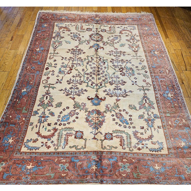 Beautiful Mid-20th century Turkish Oushak Rug. Hand-knotted in Turkey in the mid-1900s. This beautiful rug features a...