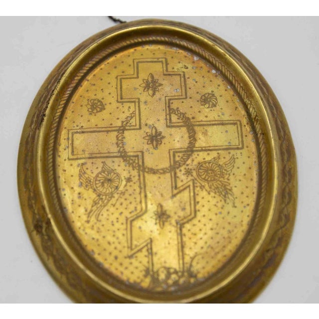 Pair of gilt porcelain plaques is a decorative object realized in the early 20th Century. Liturgical discs depicting...