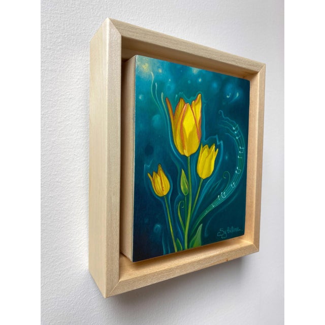 This oil painting features vibrant yellow tulips set against a deep blue background, creating a striking contrast that...