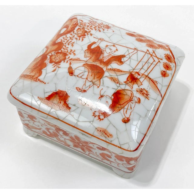 Charming vintage porcelain lidded box featuring whimsical Asian scene to lid and decorated sides to base. Footed with...