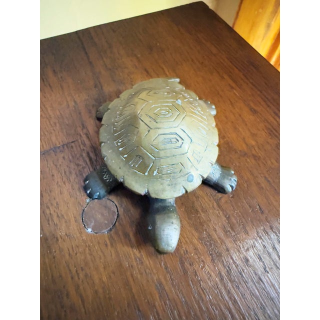 Vintage 1970s brass turtle keepsake box with a removable shell that lifts to reveal a concealed storage compartment. A...