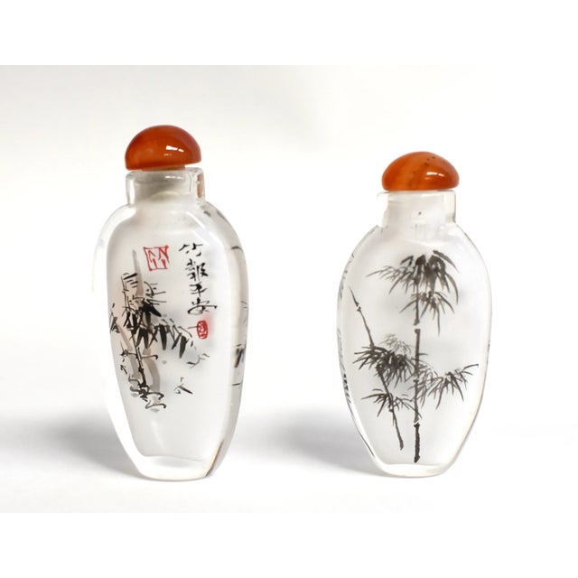 Our snuff bottles are topped with gemstone grade agate lids and 100% hand painted from within. The Chinese art of églomisé...