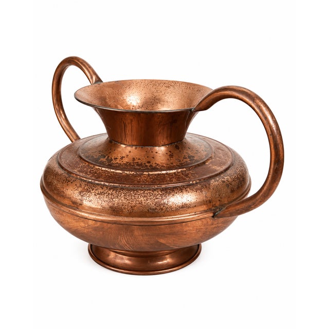 A beautifully aged French copper vessel featuring elegant twin handles and a warm, naturally developed patina. Crafted...