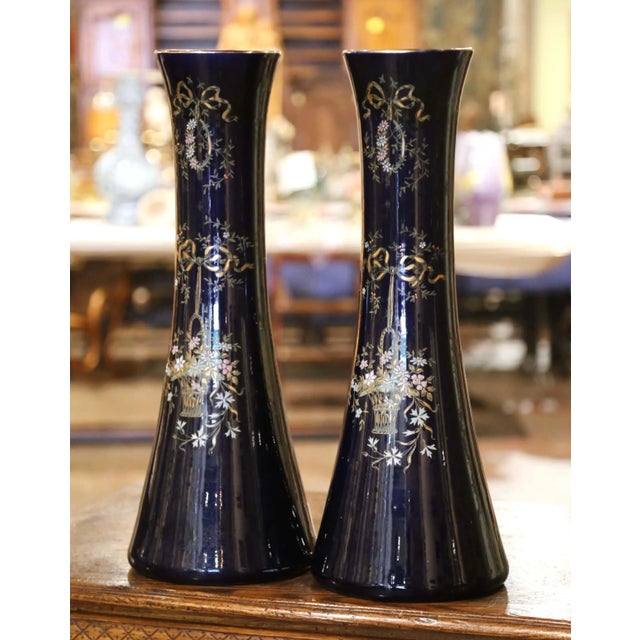 Decorate a console or a buffet with this elegant pair of antique vases from Paris. Crafted circa 1890, the tall...
