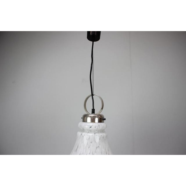 Elegant adjustable pendant lamp produced in Czechoslovakia during the 1970s. This refined Mid-Century Modern fixture...