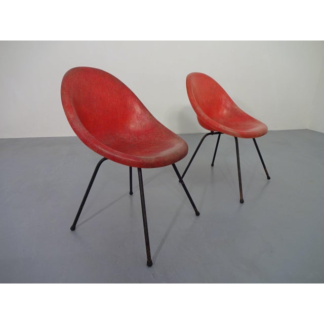 Two French chairs made of red fiberglass from the 1960s.