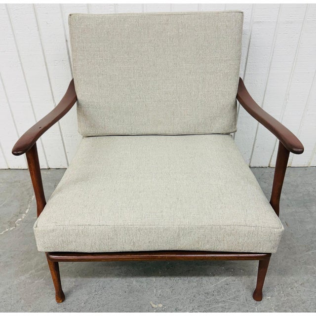 This listing is for a Mid-Century Modern Walnut Lounge Chair. Featuring a solid wood frame, curved arms, spindle backrest,...