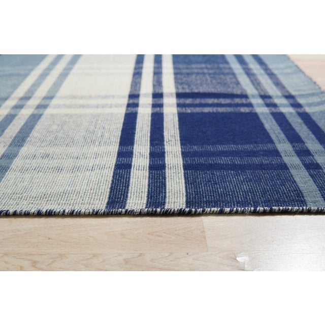 Sophisticated Elegant Blue Flatweave Wool Rug, Country of Origin: India. This exceptional flatweave piece showcases a...