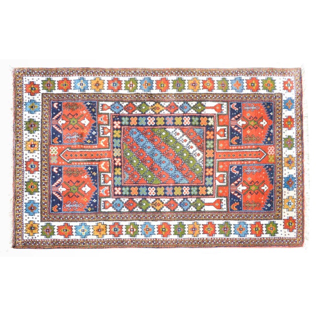 A stirking vintage Anatolian Turkish rug with a richly colored pattern of stylized flowers, chickens, and trees-of-life,...
